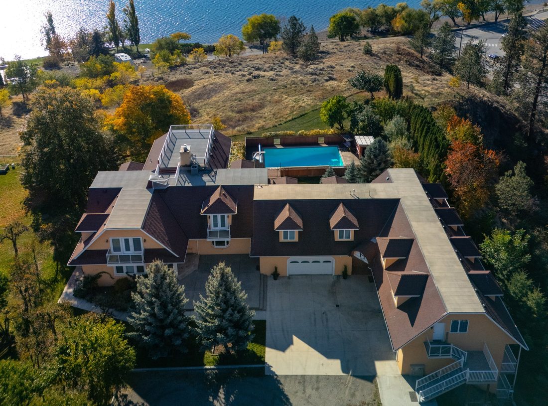 Bird's-eye view directly over the main residence, pool and grounds