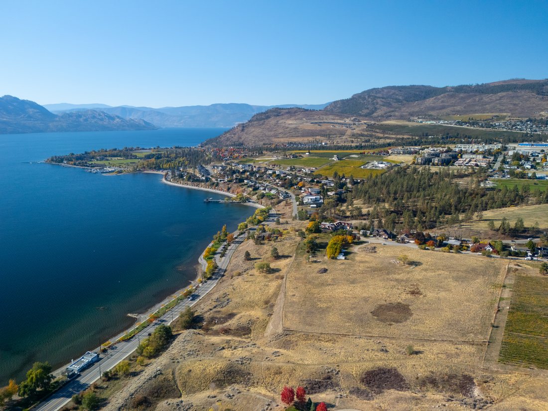 Aerial view of the property's open acreage above the Okanagan Lake shoreline